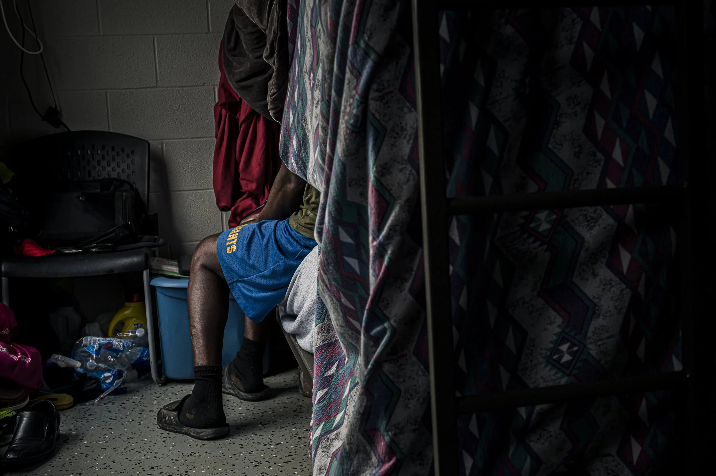  A man watches a religious sermon from his bunkbed at  Cervini Farms, in Leamington., Ont., on Sunday, Aug., 1, 2021. The bunkbeds used by migrant workers to sleep in  are also the only private space they have to themselves in a housing facility that