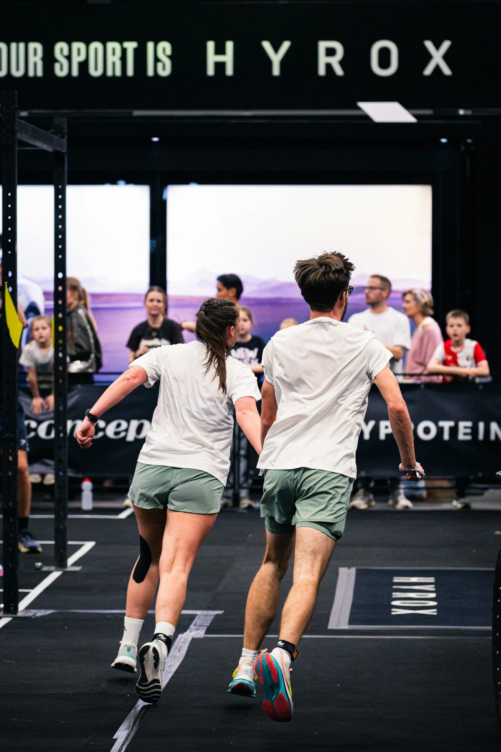 Man and women competing at hyrox competition