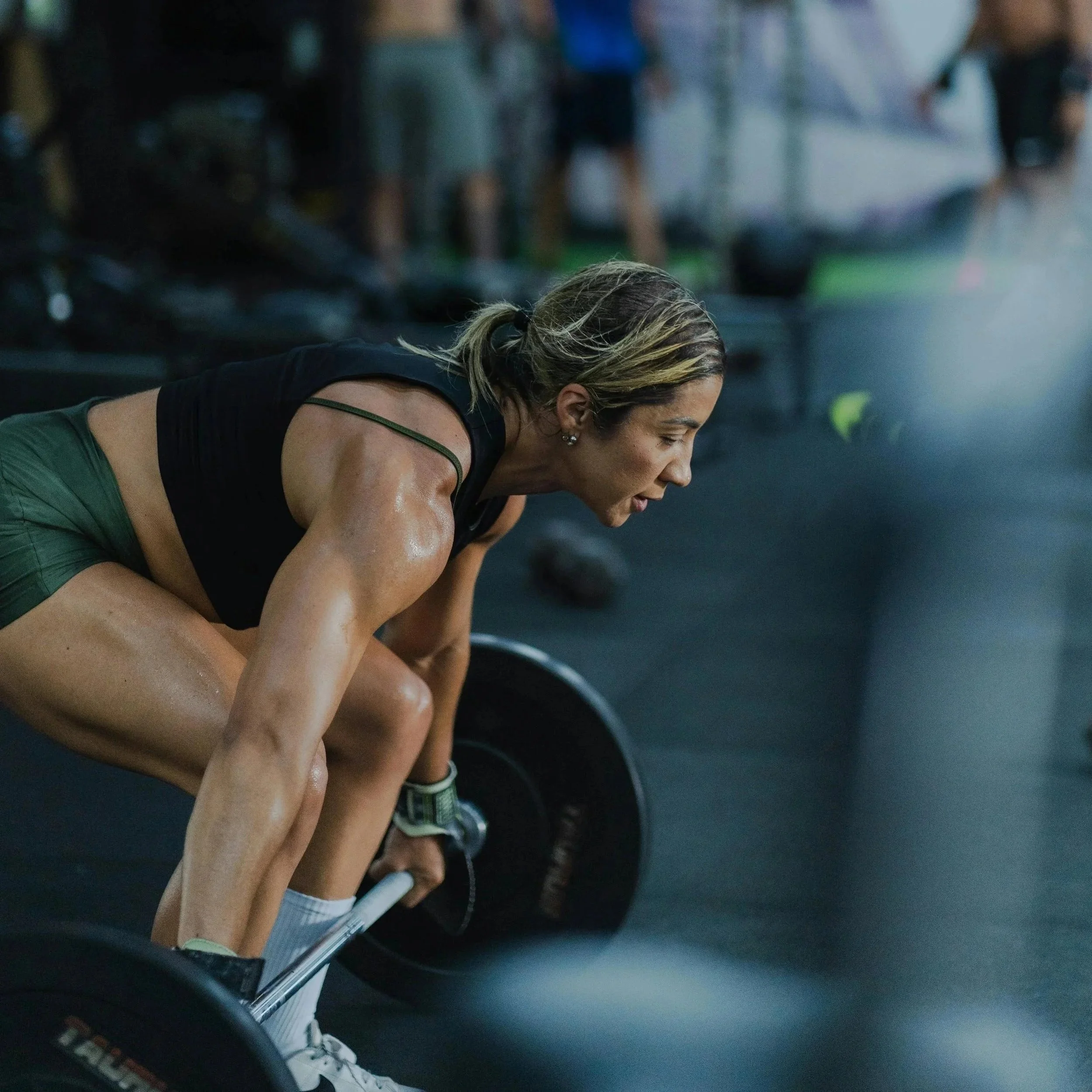 Athlete performing deadlifts in gym