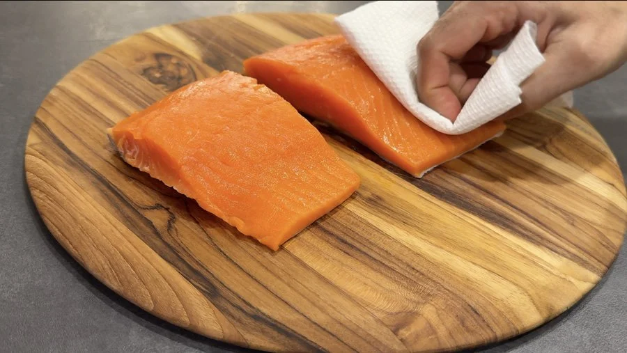 patting salmon dry with paper towel