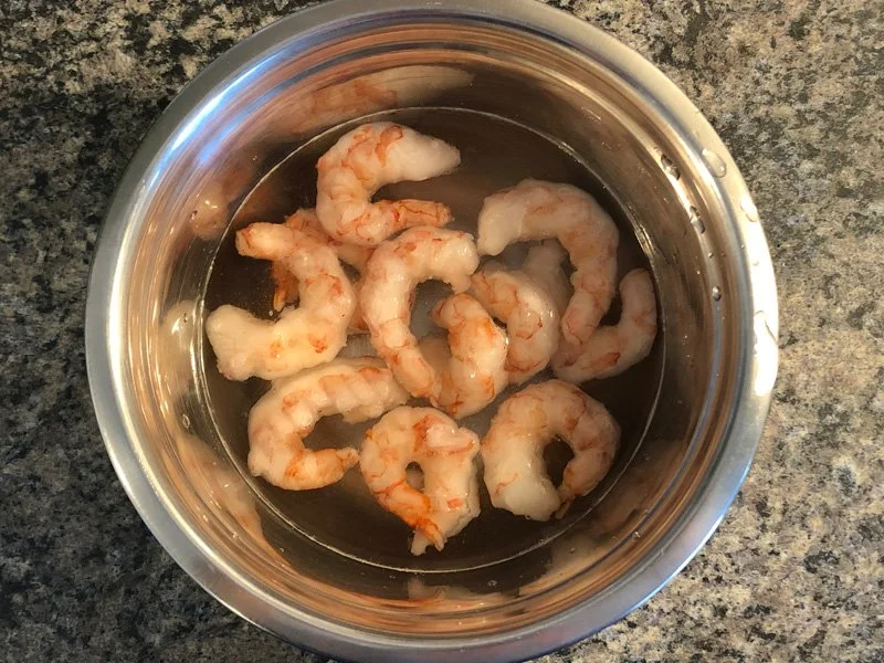 Shrimp thawing in a bowl