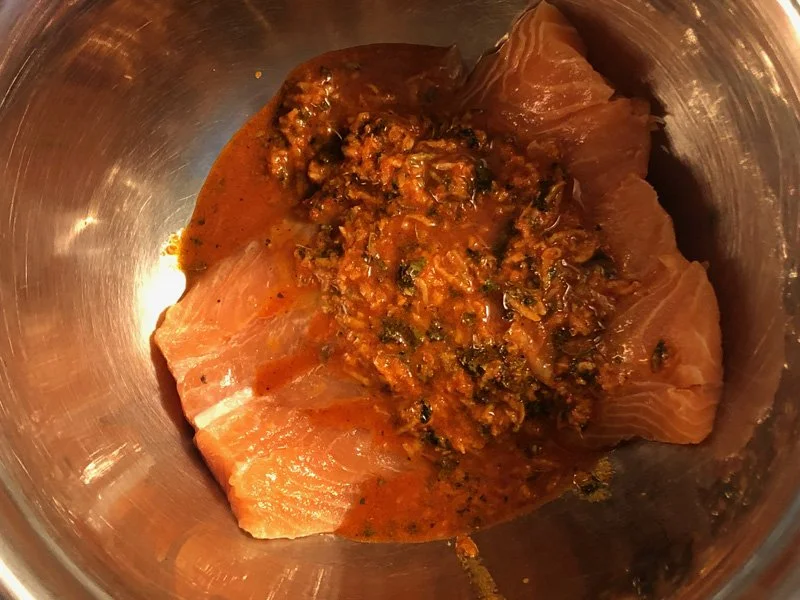 adding salmon to marinade