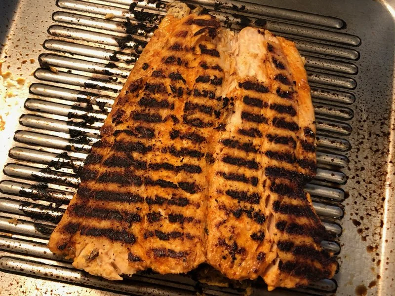 flipping grilled tandoori salmon