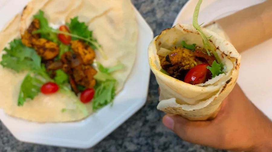 holding healthy chicken shawarma wrap