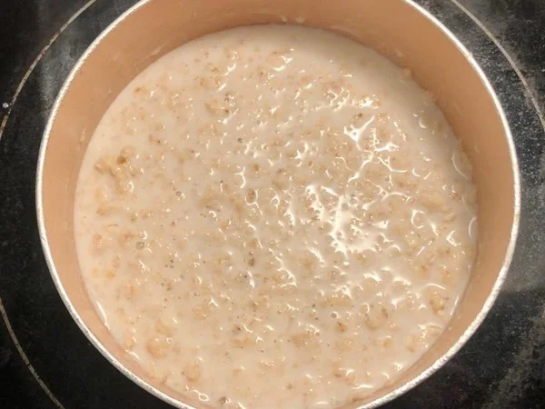 oats simmering in saucepan with milk