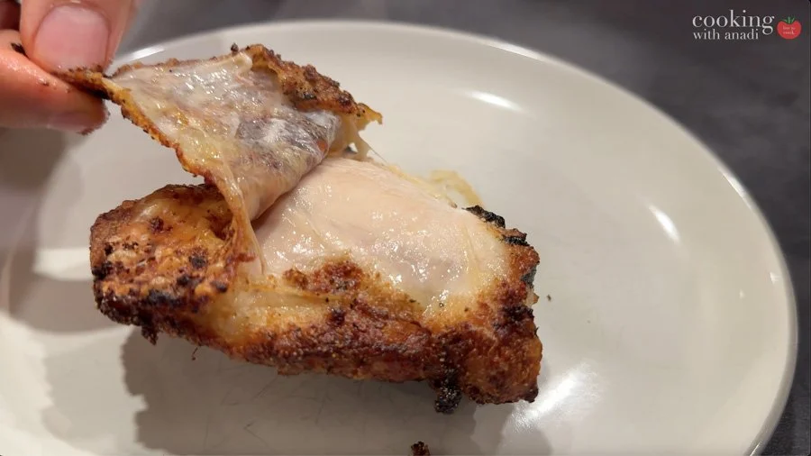 peeling off crispy skin on chicken thighs