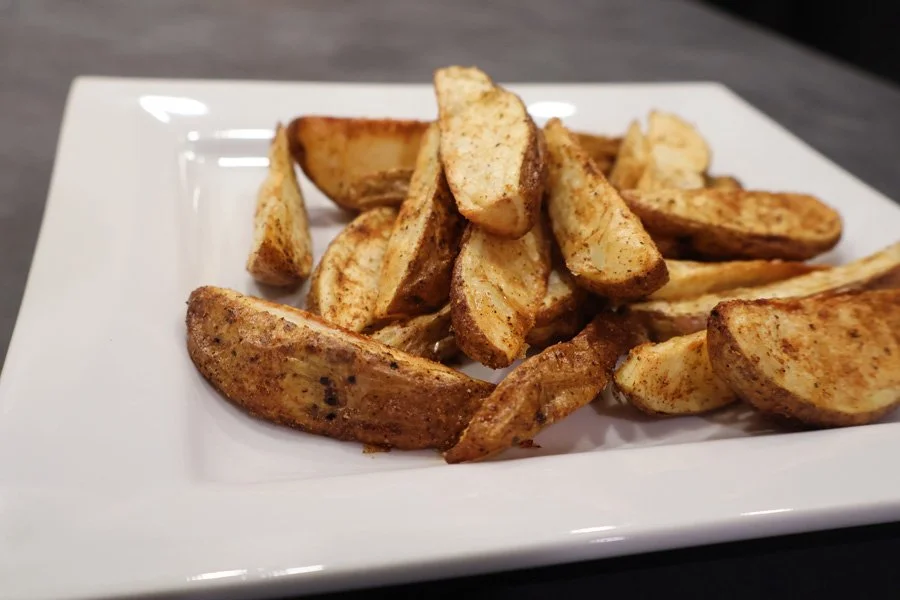 plate of air fryer cajun potato wedges