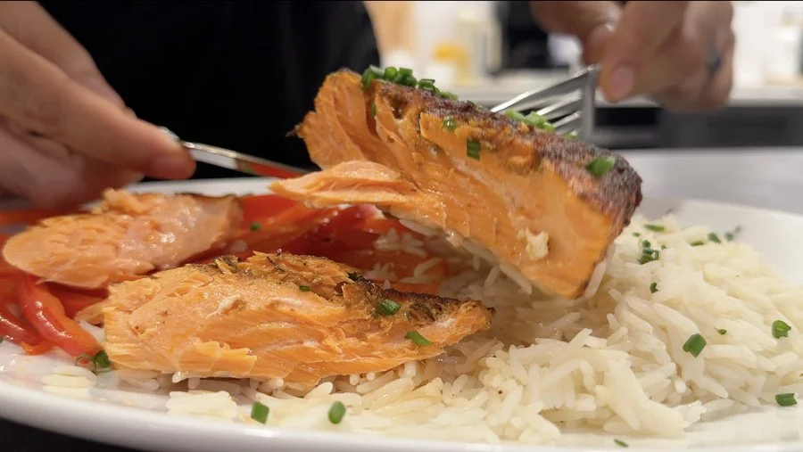 slicing into air fried salmon
