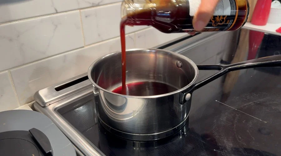 adding teriyaki sauce to pot