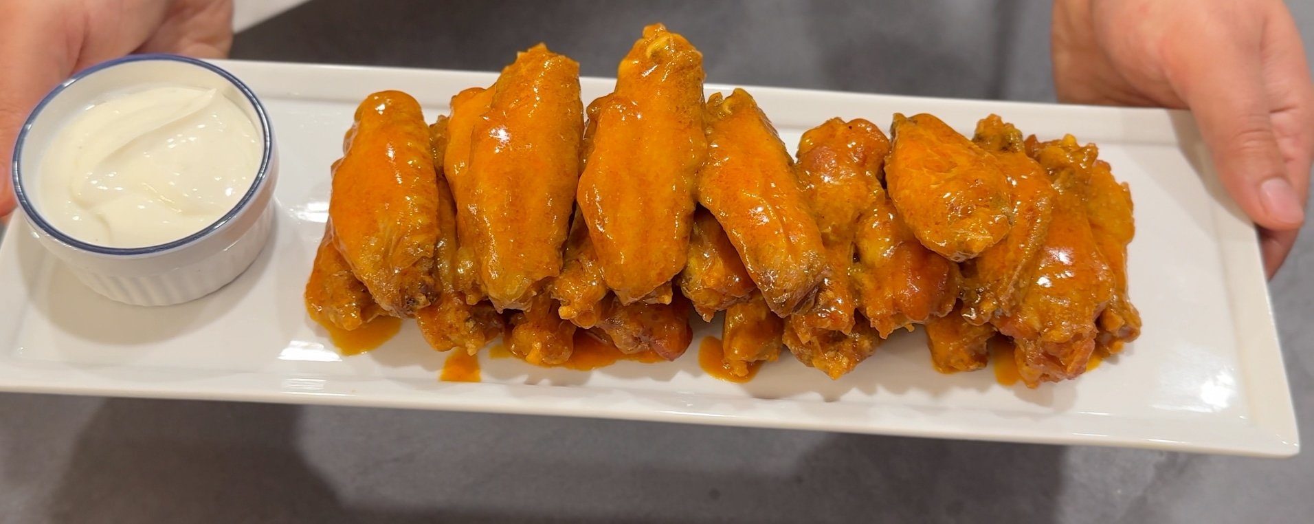 photo of buffalo chicken wings with sauce