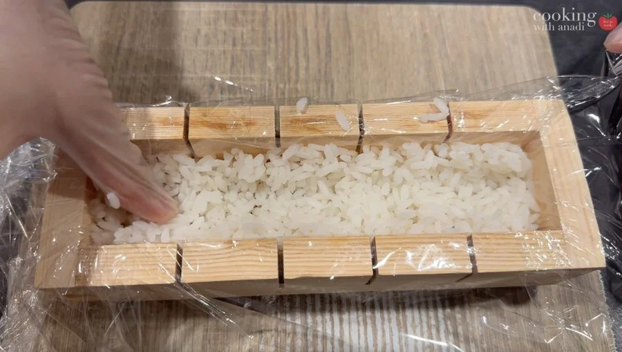 adding rice on top of salmon