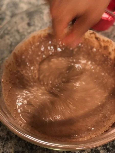 mixing cocoa in a saucepan