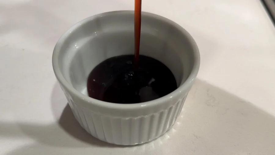 pouring teriyaki sauce into ramekin