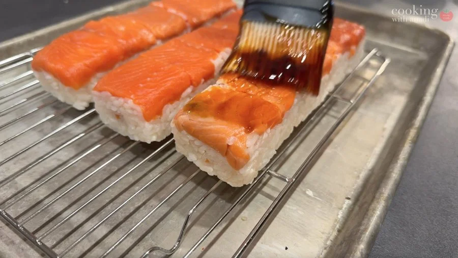 brushing teriyaki reduction over sushi