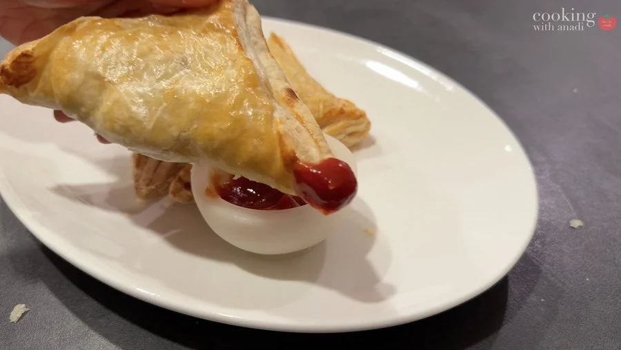 aloo puff patty dipped in ketchup