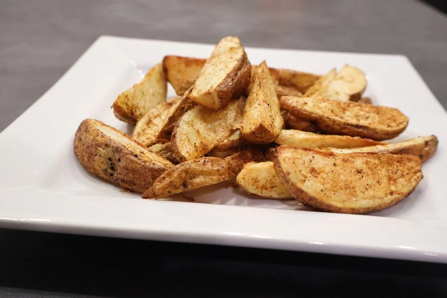 close up of air fryer cajun potato wedges