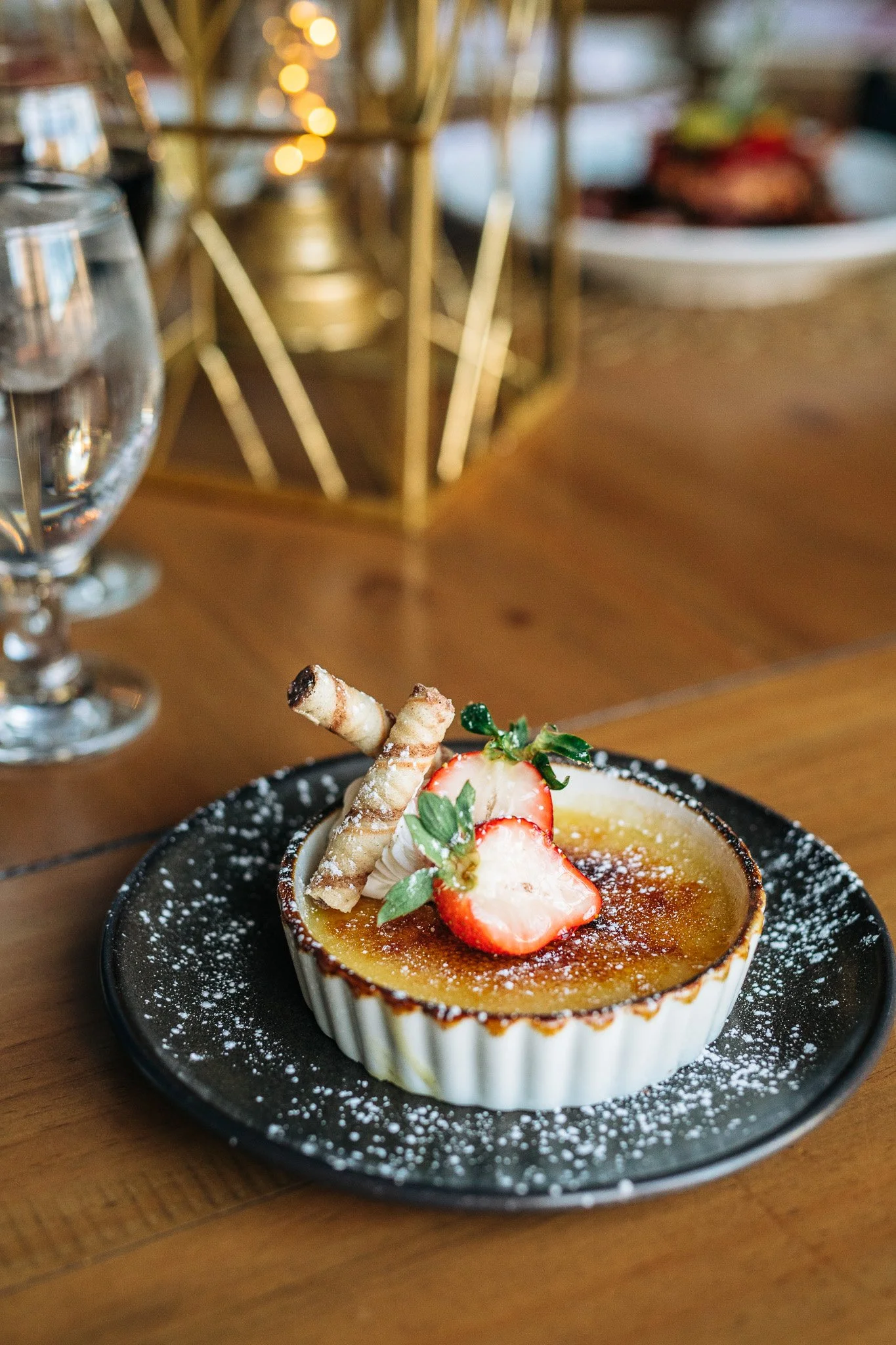 Custard dessert with powdered sugar, strawberries and pastry