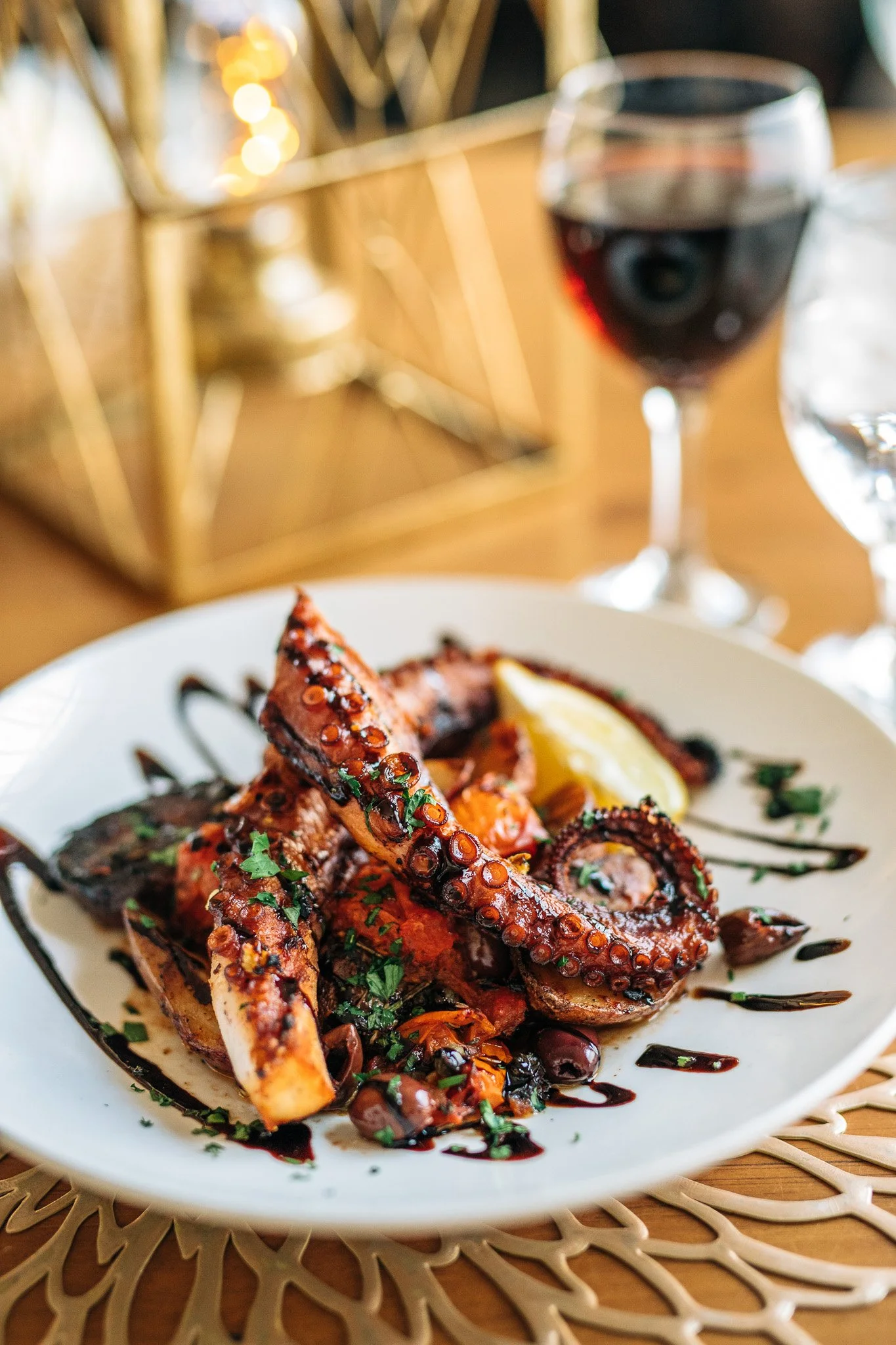 Grilled octopus served with lemon and olives