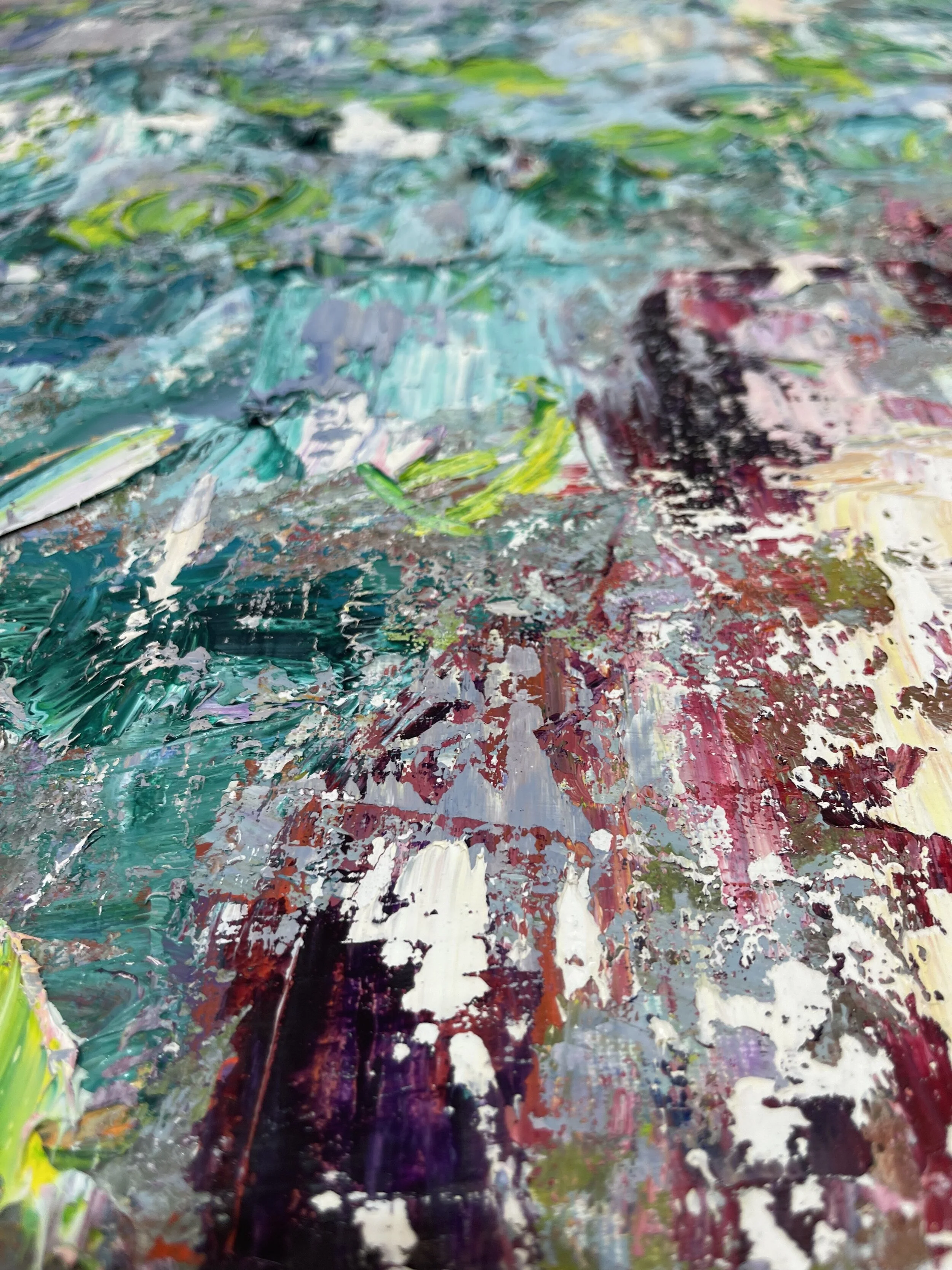 Close-up of an abstract painting with thick, textured brushstrokes in various colors including greens, blues, reds, pinks, purples, and whites.