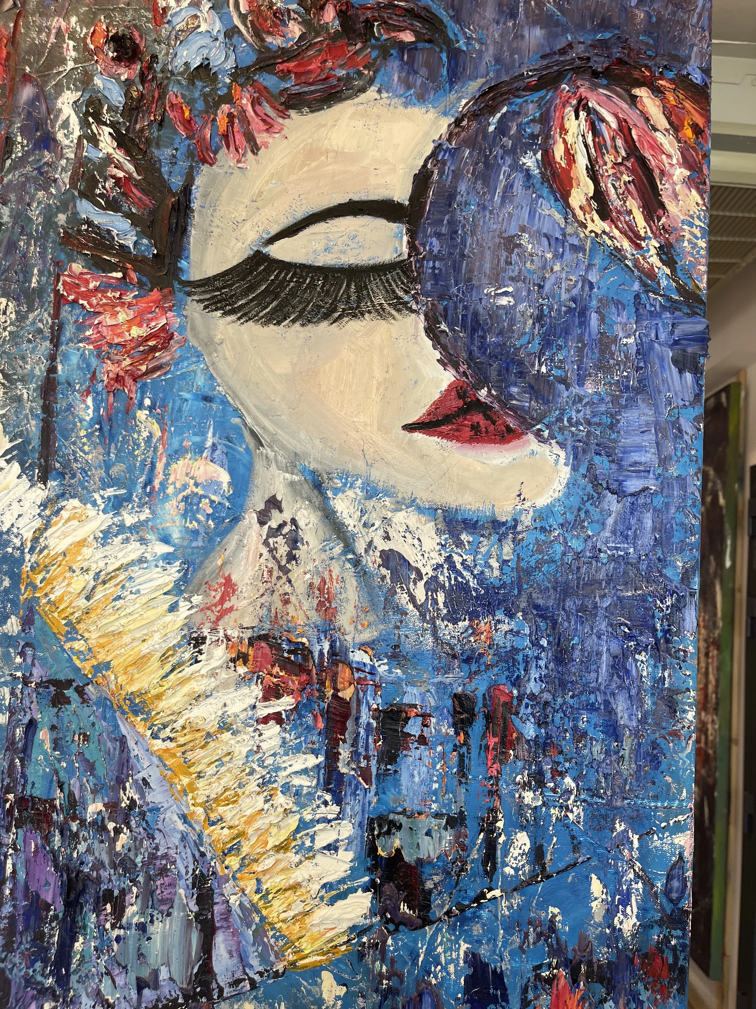 Abstract painting of a woman's face with closed eyes, red lips, and dark eyelashes against a vibrant, textured background of blue, purple, red, yellow, and white brushstrokes.