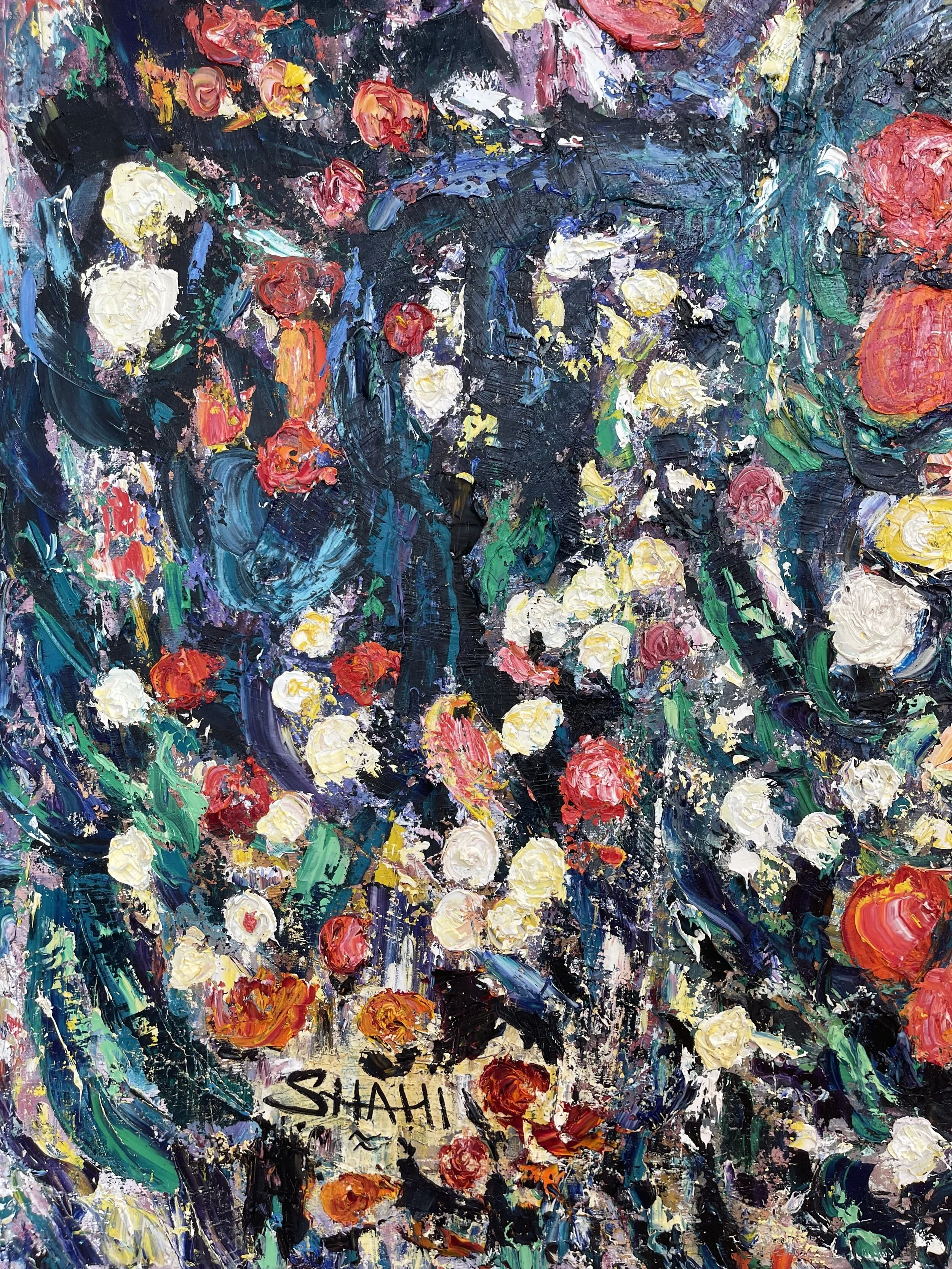 A vibrant abstract painting with thick, textured brushstrokes of various colors including white, red, yellow, blue, purple, and green, creating a lively floral-like composition. The artist's signature 'SHAHI' is visible in the lower left corner.