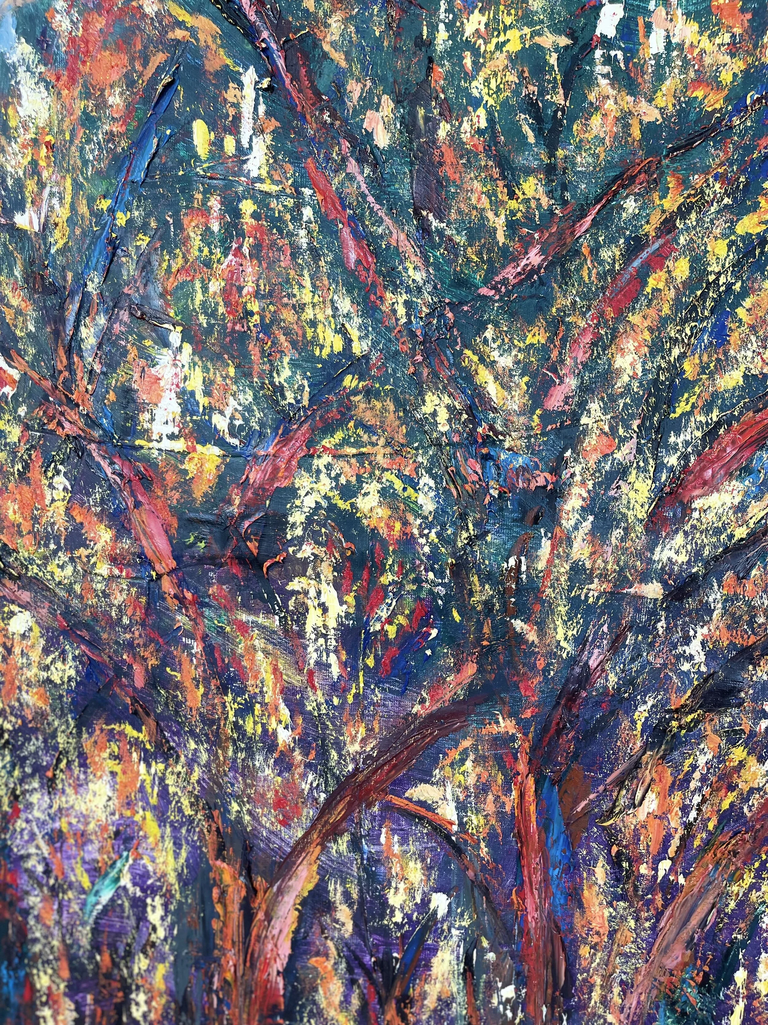 Close-up of an abstract colorful painting with textured brushstrokes, featuring blues, reds, yellows, and pinks.