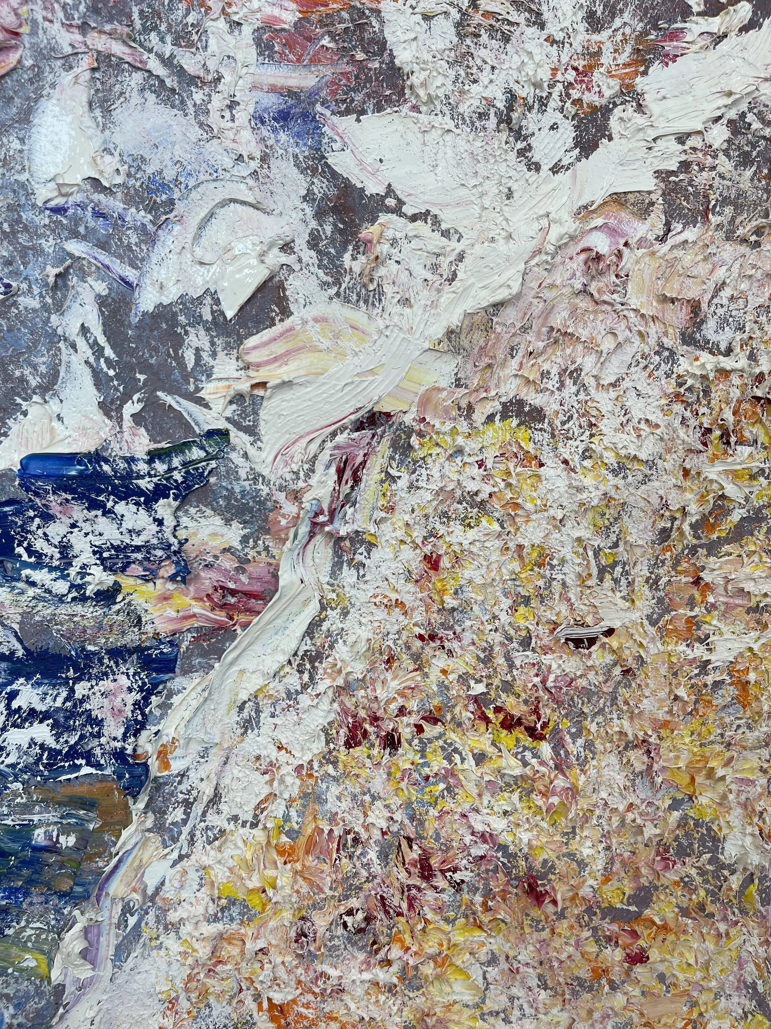 Close-up of an artist's palette with thickly applied mixed oil paints in various colors, including white, pink, yellow, and blue.