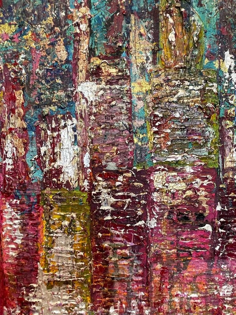 Abstract painting with thick textured brushstrokes in colors of pink, red, white, yellow, green, and blue, resembling a cityscape or stacked buildings.