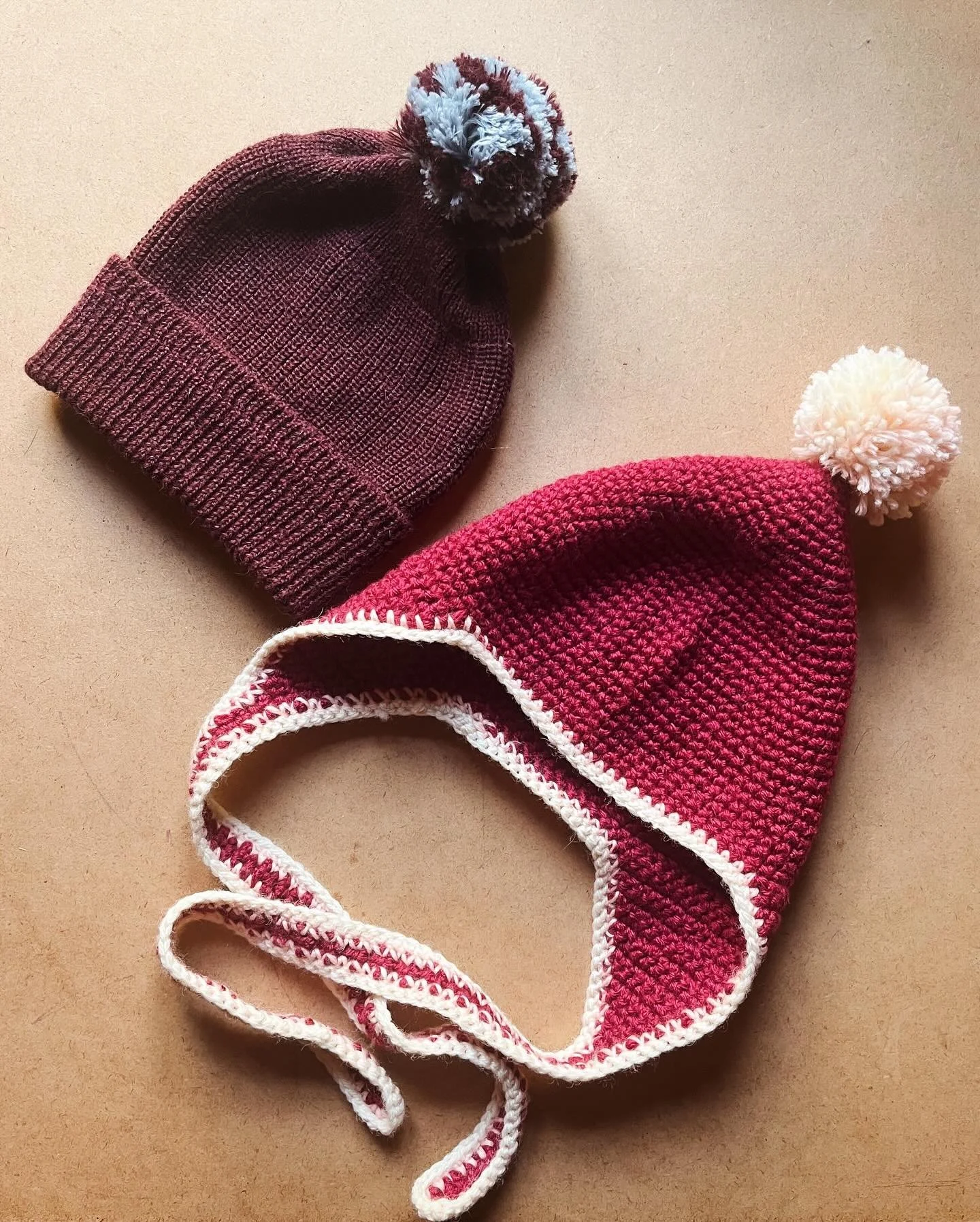 Winter hats I made for my daughter 🧶 there&rsquo;s one hand-crocheted pixie hat and one classic #keepersknitwear beanie in a sweet new burgundy shade - both with the obligatory pom-poms and made from deadstock wool 🤤 if you want to order handmade h