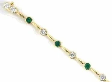 A chic 18-karat yellow gold straightline bracelet alternating eight round diamonds with seven fine round emeralds.