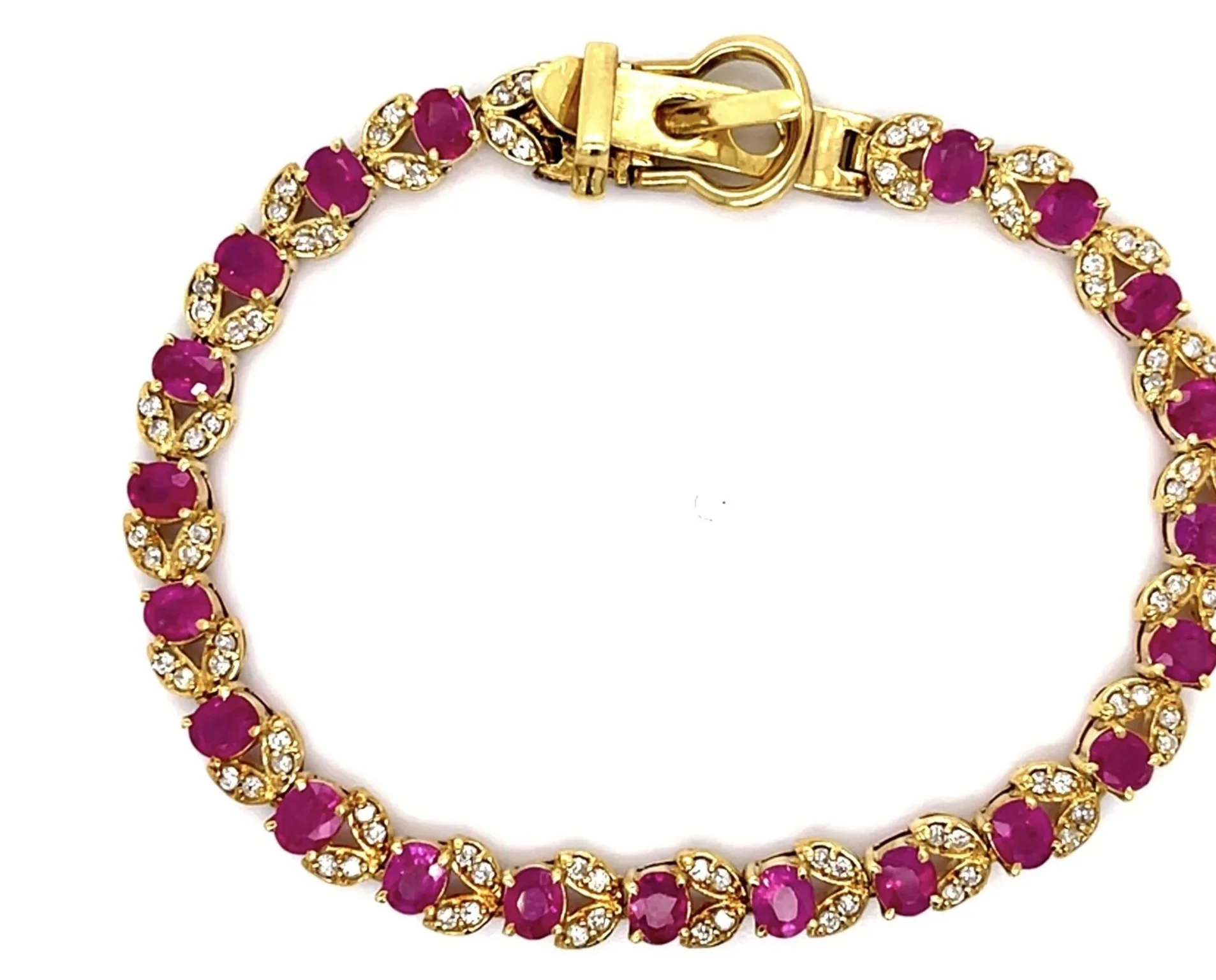 From the 1960s, an 18-karat yellow gold bracelet comprising vivd magenta colored Burmese rubies weighing about 5.84 carats total. 