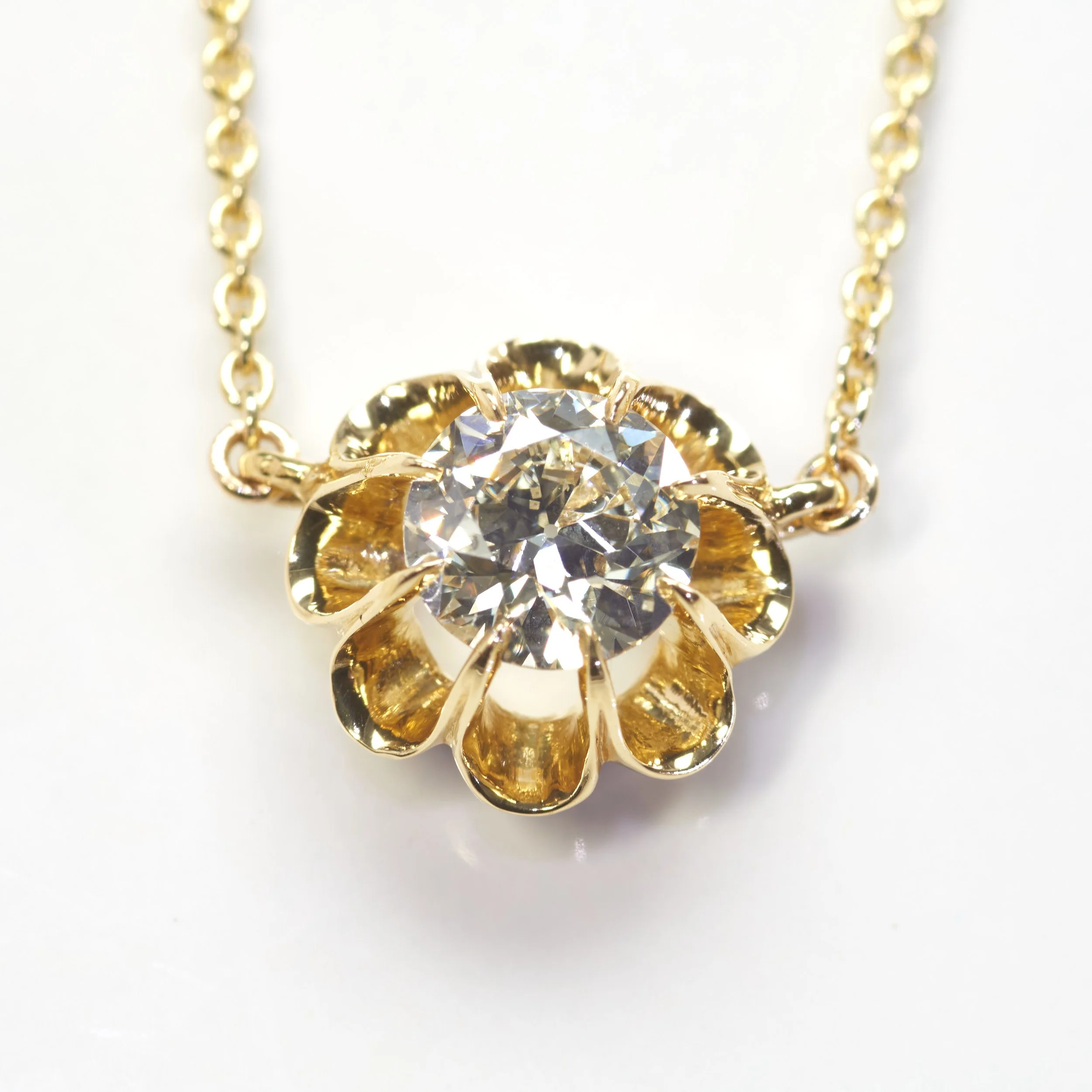 In 14-karat yellow gold, an eight-prong buttercup setting holds an old European cut diamond weighing 0.91 carat. With 18" cable link neck chain.