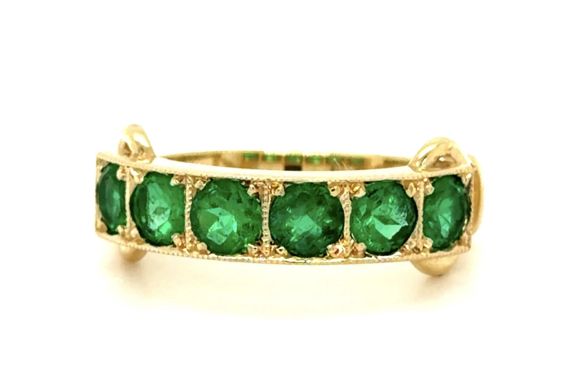 Fine Colombian emeralds weighing about 1.00 carat total are showcased in this 14-karat yellow gold ring.