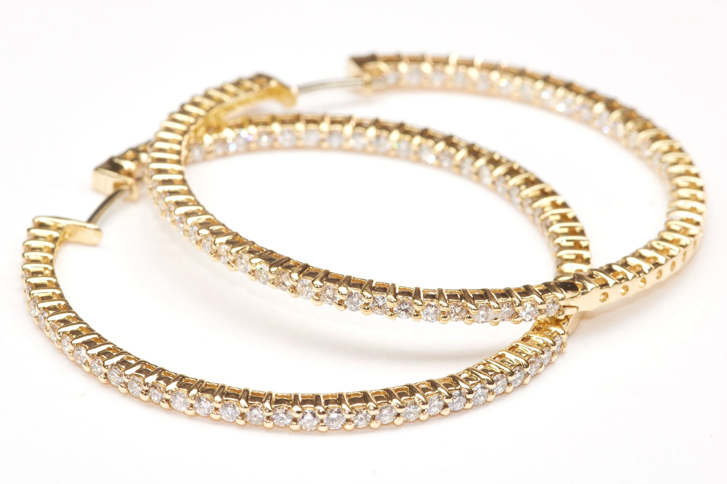 Large yet delicate, these 18-karat yellow gold hoop earrings are set with 122 diamonds weighing about 2.50 carats total. Each earring measures 1 3/4" in diameter.

