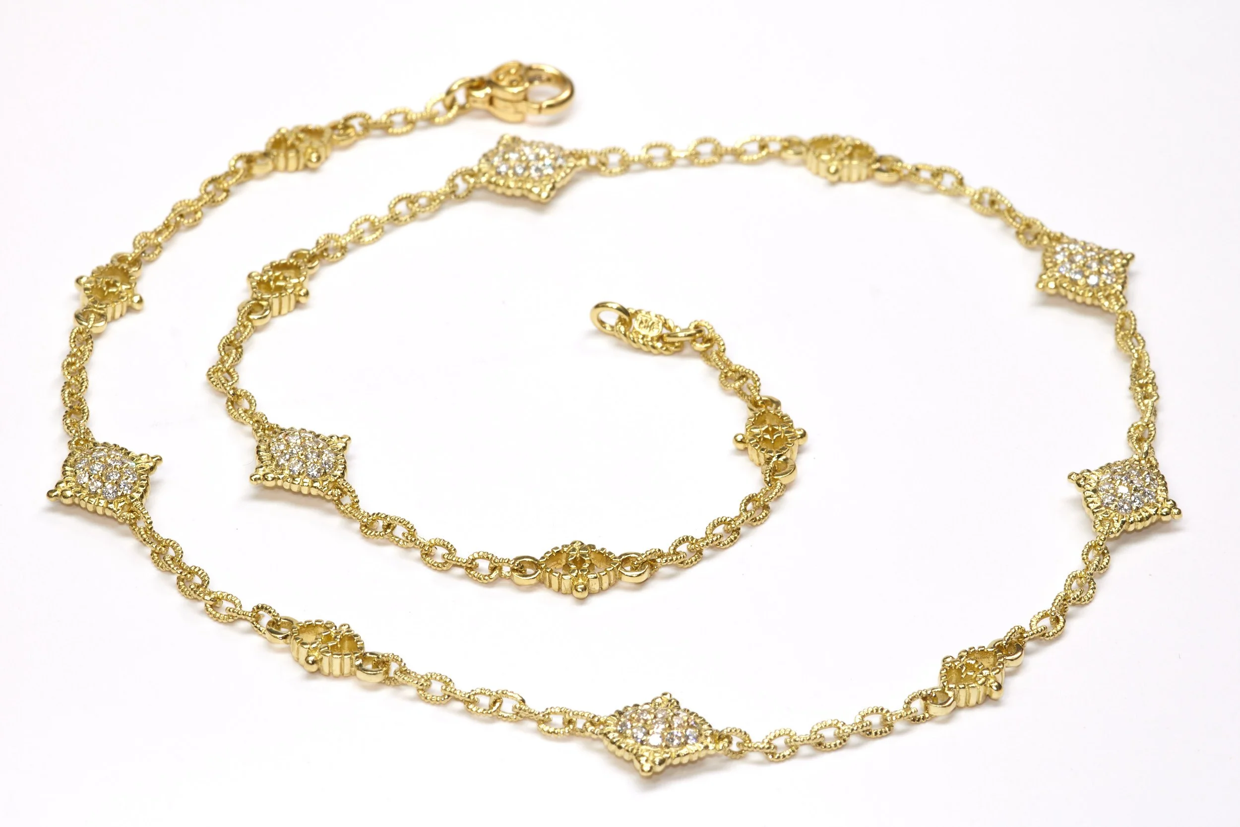 An 18-karat yellow gold link necklace by Judith Ripka is mounted with 168 diamonds on both sides of the six stations that weigh about 2.52 carats total. 