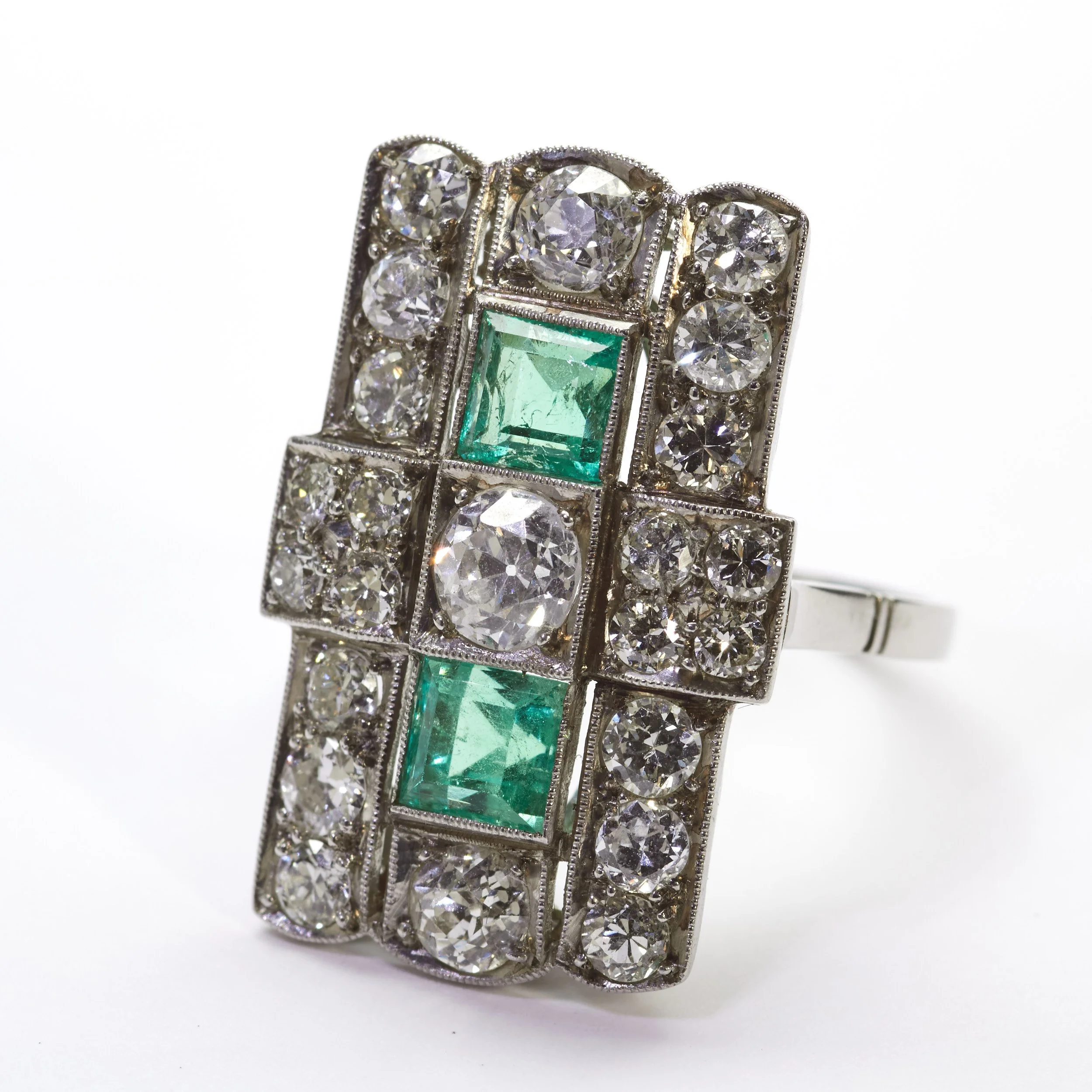 Grand, sleek and luxurious describes this platinum Art Deco ring, which is mounted with 22 diamonds weighing about 2.00 carats total and two emeralds weighing about 1.60 carat together. The top measures 1" top to bottom. Fingers size 6 1/2. 