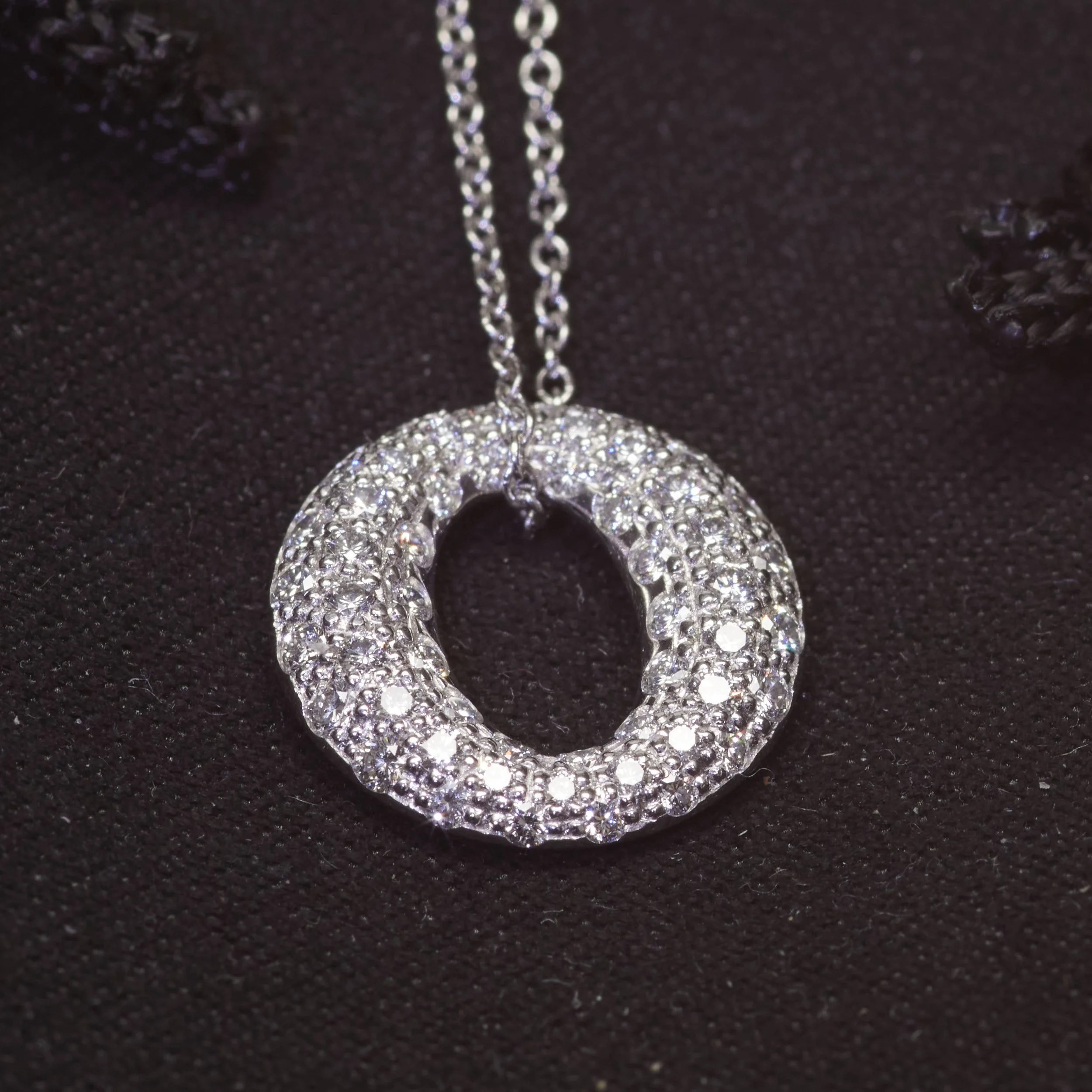 Dazzling pendant in platinum by Peretti for Tiffany & Co. From the Sevillana collection, it fairly dances with fifty-four diamonds weighing about 0.90 carat total. Measures 1/2" x 1/2".