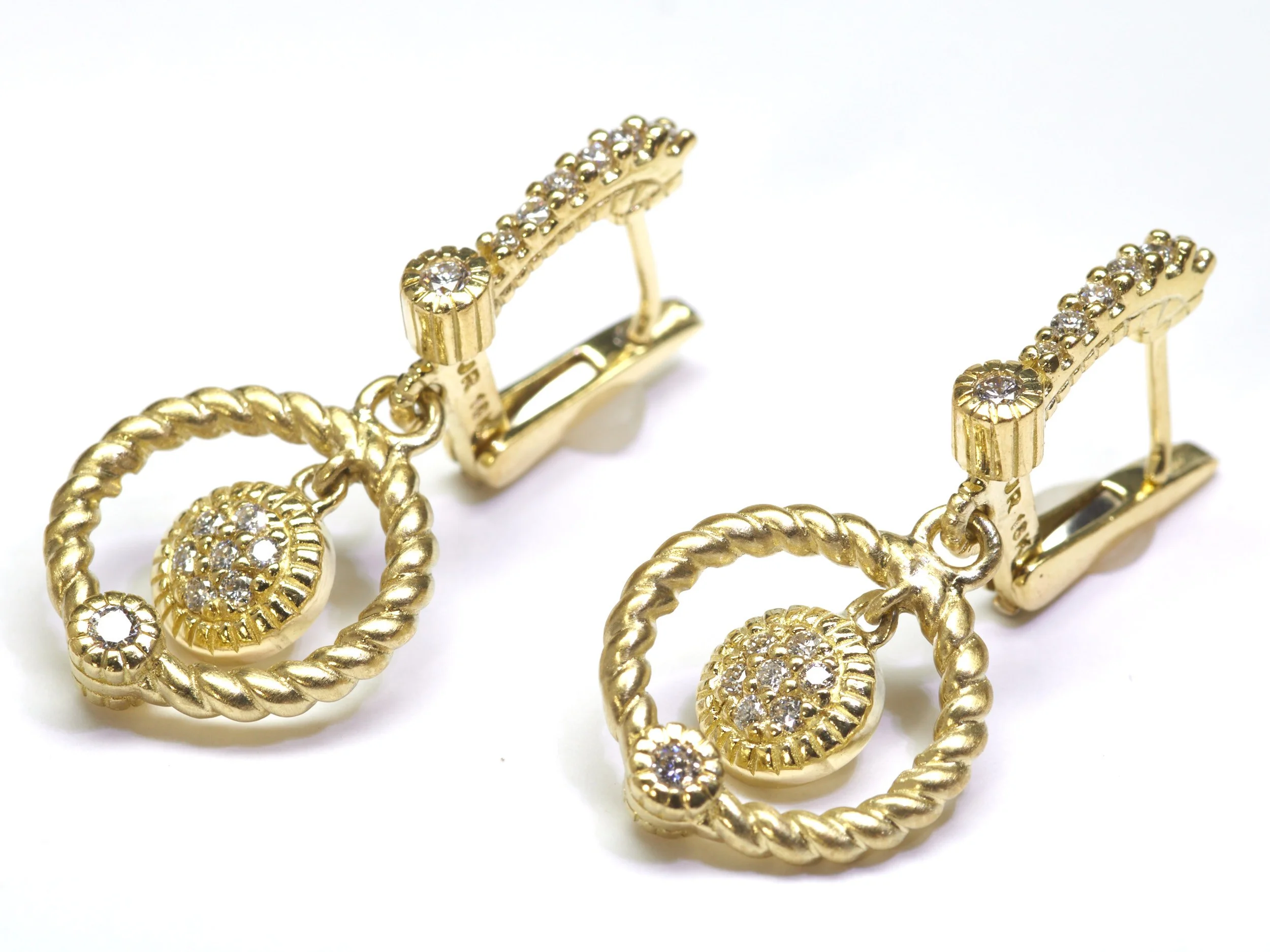 By Judith Ripka, These 18-karat yellow gold earrings by Judith Ripka each dangle gracefully at 1 1/4" and are set with 30 diamonds weighing about 0.34 carat total.