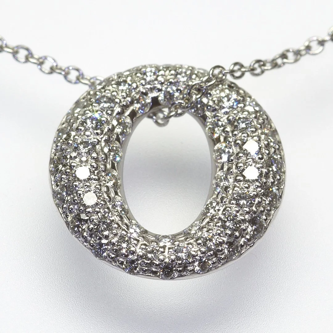 This dazzling platinum Sevillana pendant by Peretti for Tiffany & Co. is pave-set with fifty-four diamonds weighing about 0.90 carat total. It measures 1/2" x 1/2".