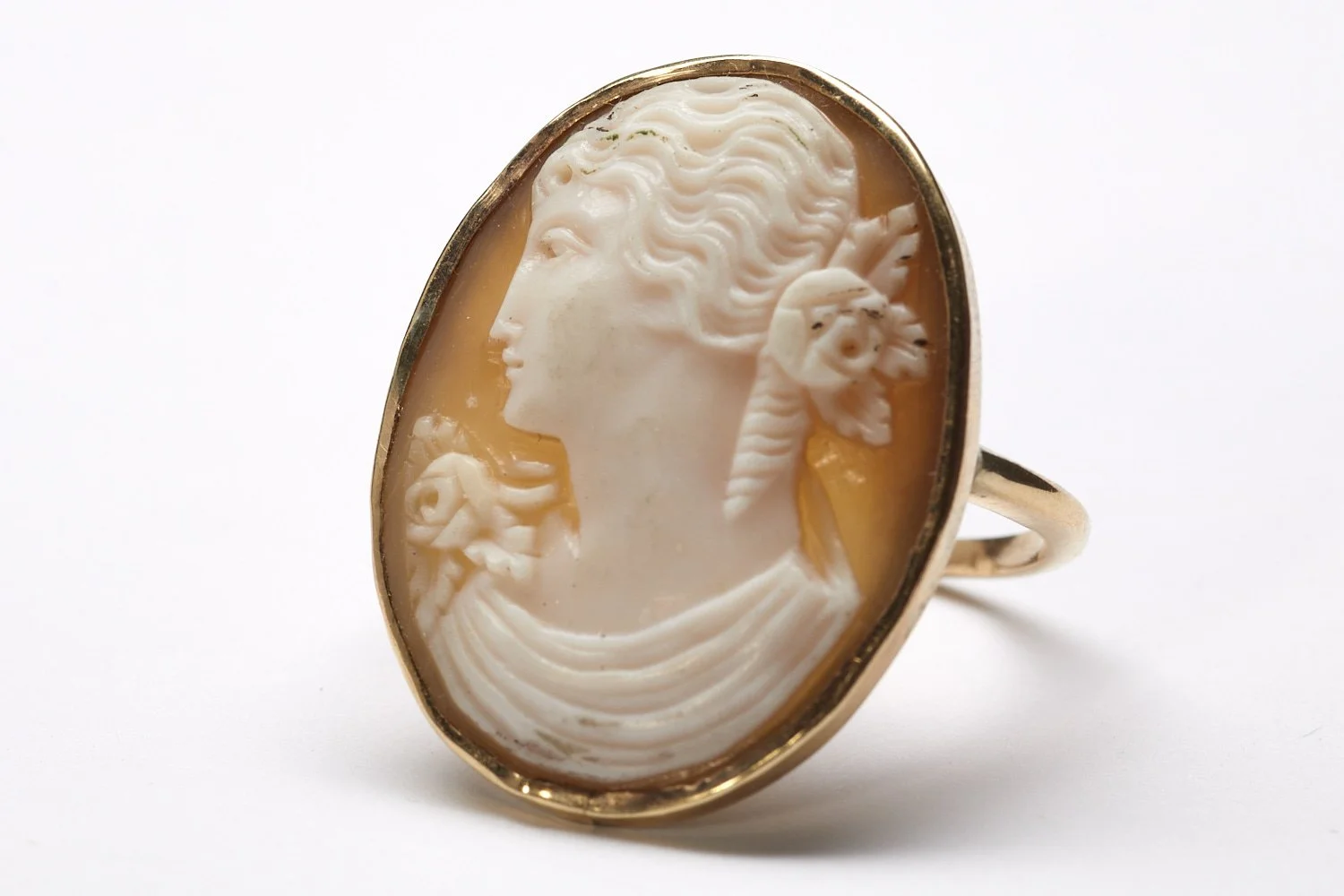 This 14-karat yellow gold ring measures about 1 x 3/4" and is set with a shell cameo, c. 1920s.