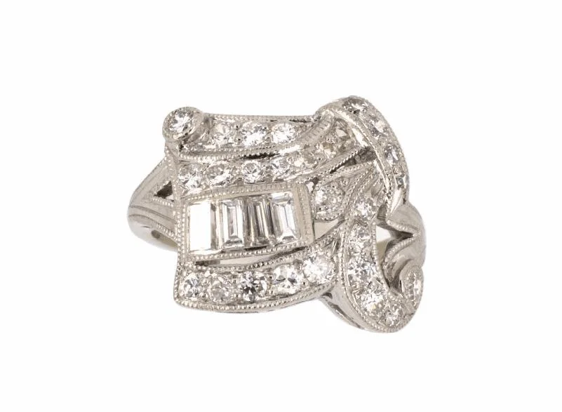 A platinum ring from the late Art Deco period, designed as a folded ribbon, set with 31 diamonds weighing abougt 1.10 carats total.