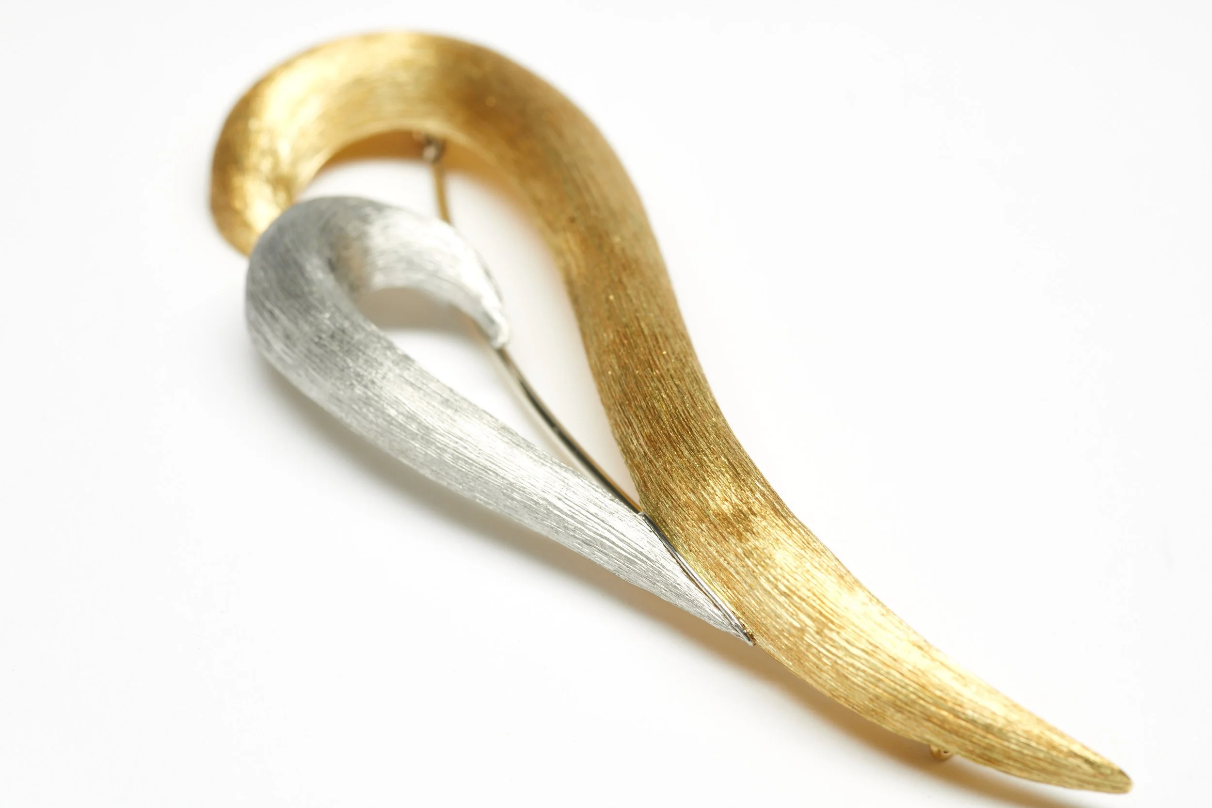 Legendary U.S. designer Henry Dunay created this 18-karat yellow gold and platinum "bleeding heart" brooch in his signature Sabi finish. Impressive at 3 5/8" long.