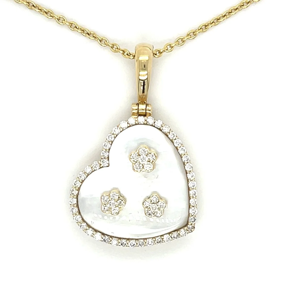 A sweet 18-karat yellow gold pendant showing three diamonds on a mother-of-pearl background and a diamond border.