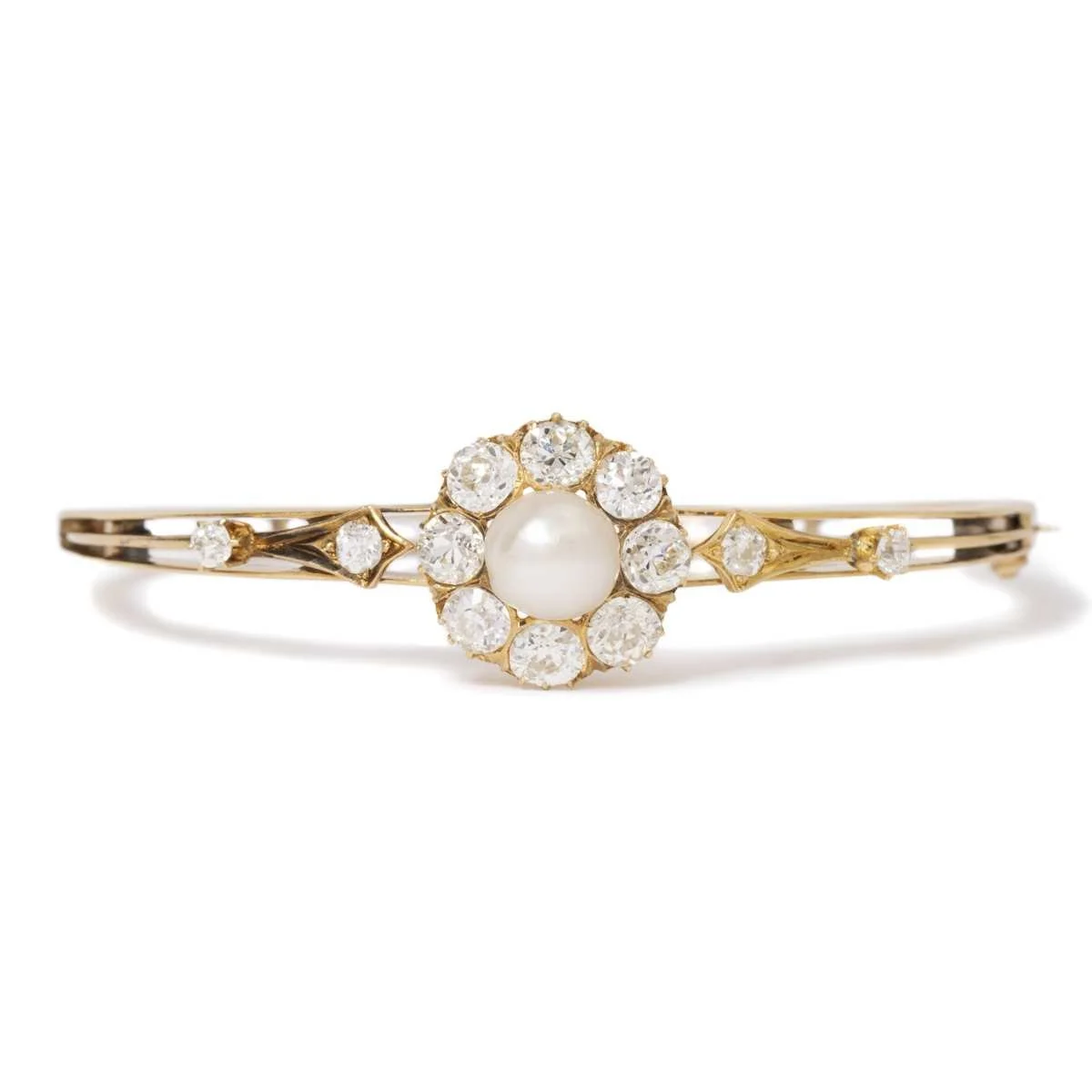 A Victorian antique bangle bracelet in 14k yellow gold with more than 4.00 carats in old-cut diamonds and a certified natural pearl center.