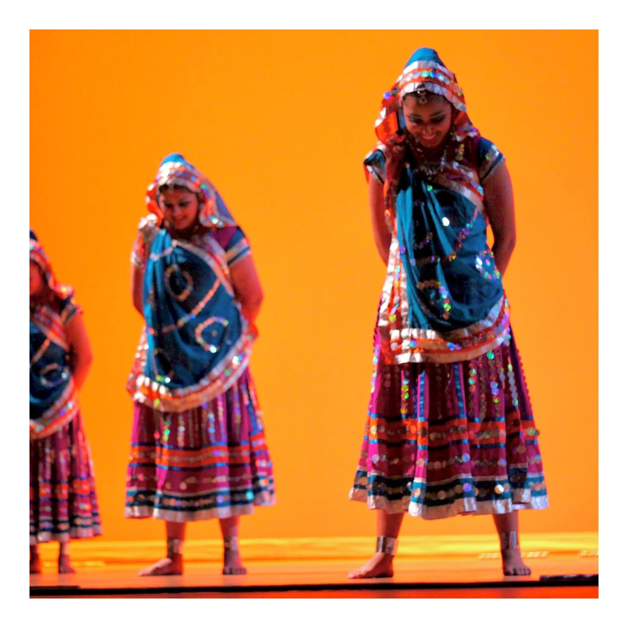  Garba  
A traditional Gujarati dance performed in community, danced in concentric circles around a female deity. It involves clapping, intricate footwork, and twirling as the group moves in unision.
