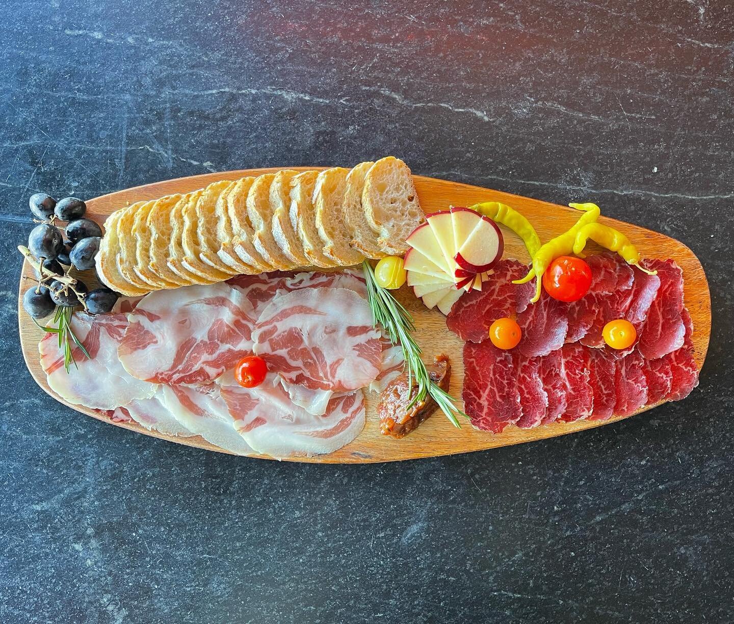 We are pleased to introduce an amazing charcuterie producer from Rockport, Maine. 
- A Small Good -
Here we are featuring Bresola and Coppa served with pickled heirloom tomatoes, piparra peppers, tomato chutney, apples, grapes and baguette.
Beginning