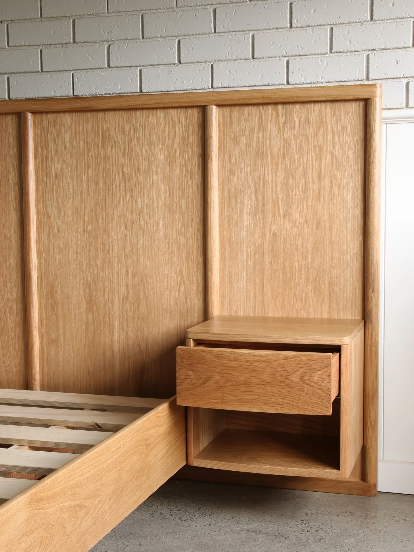 King Bed &amp; Bedsides in Oak.

This bed is designed to be built in, with PowerPoints and light switches incorporated into the bed head. The bed was made in several pieces for ease of transport and access to the upstairs bedroom. 

Made from America