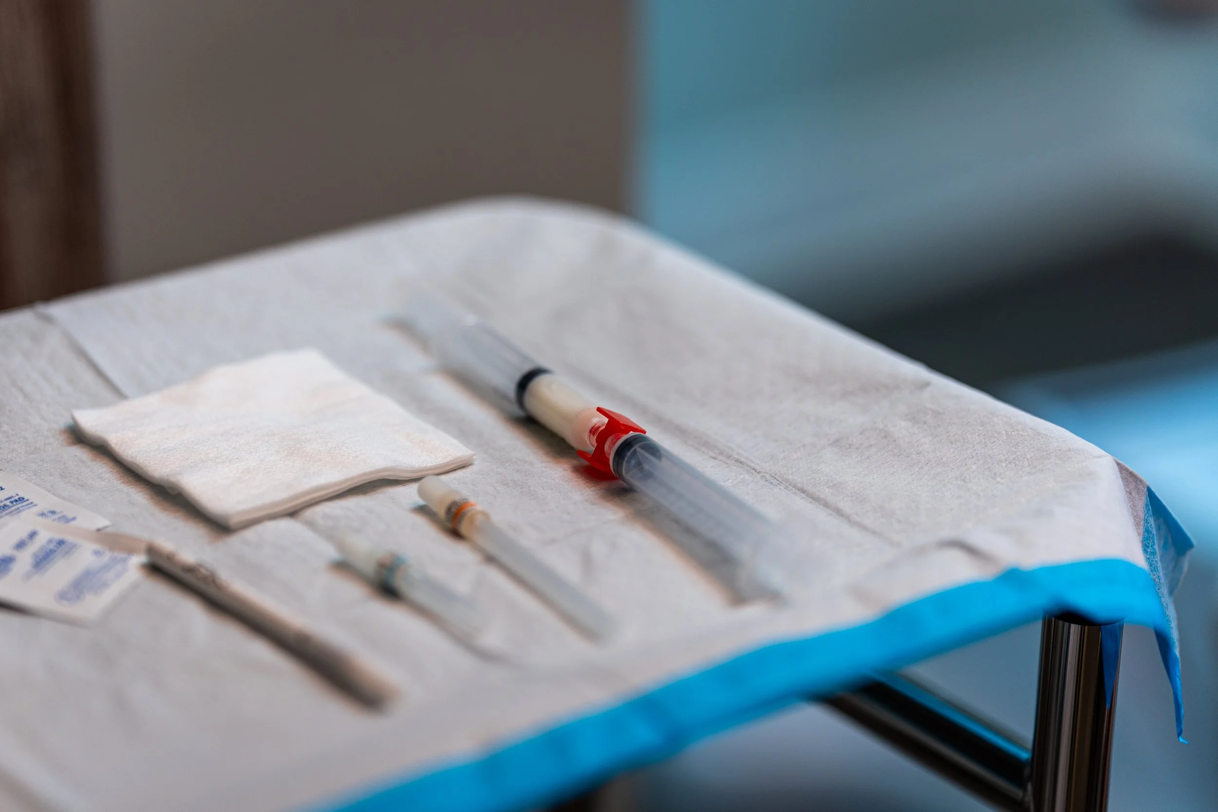 njectable treatment syringes and medical supplies arranged on sterile cloth at HYDRO Med Spa.