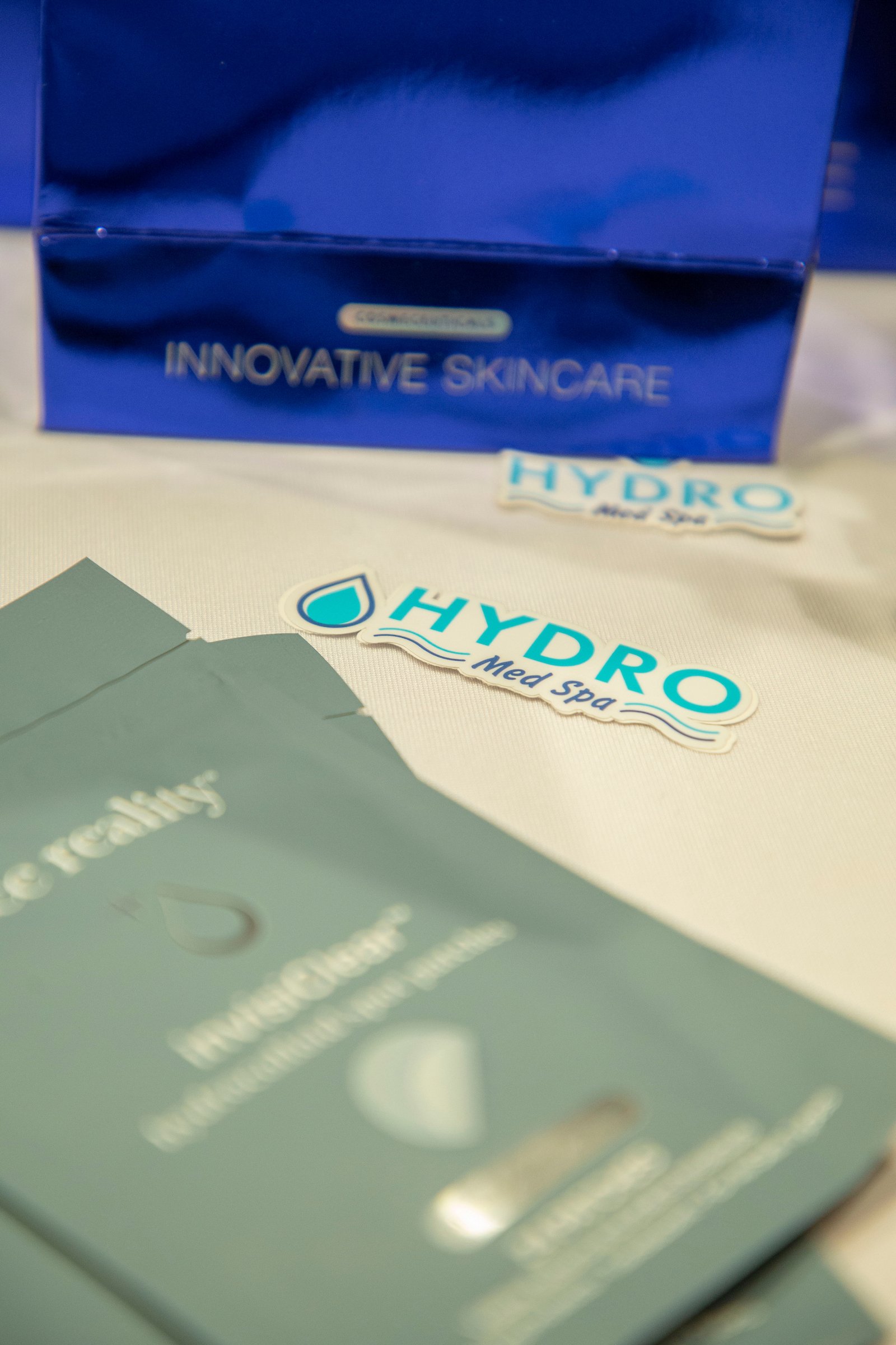 Image of a HYDRO Med Spa Sticker with a facial reality mask in front. 