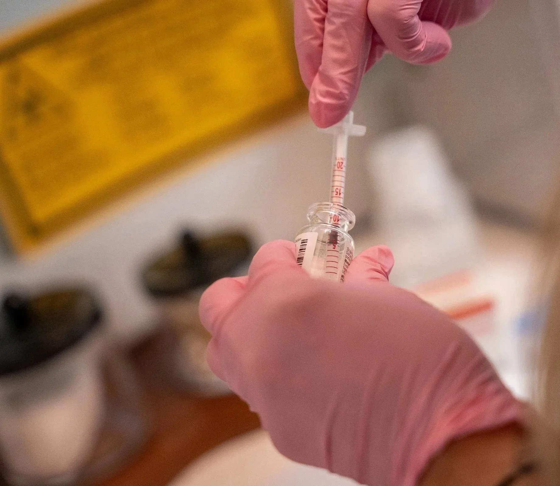 Picture of someone pulling botox out of a vial.